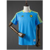 Blue Colombia T-shirt with yellow stripes and chest emblems front view