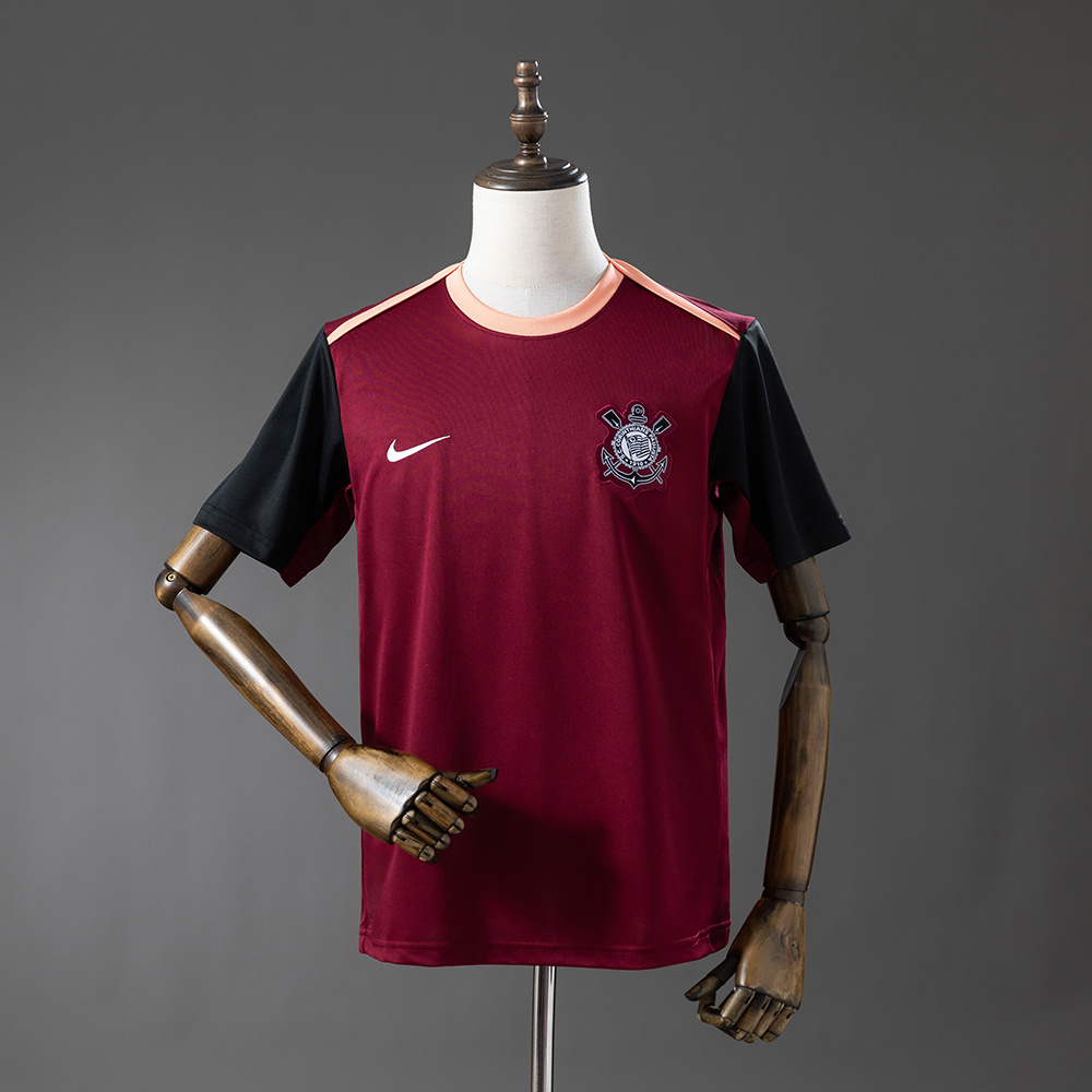 Mens Corinthians Training Kit Jersey 2026/27 Front view of the Mens Corinthians Training Kit Jersey 2026/27 in burgundy with black sleeves and peach trim
