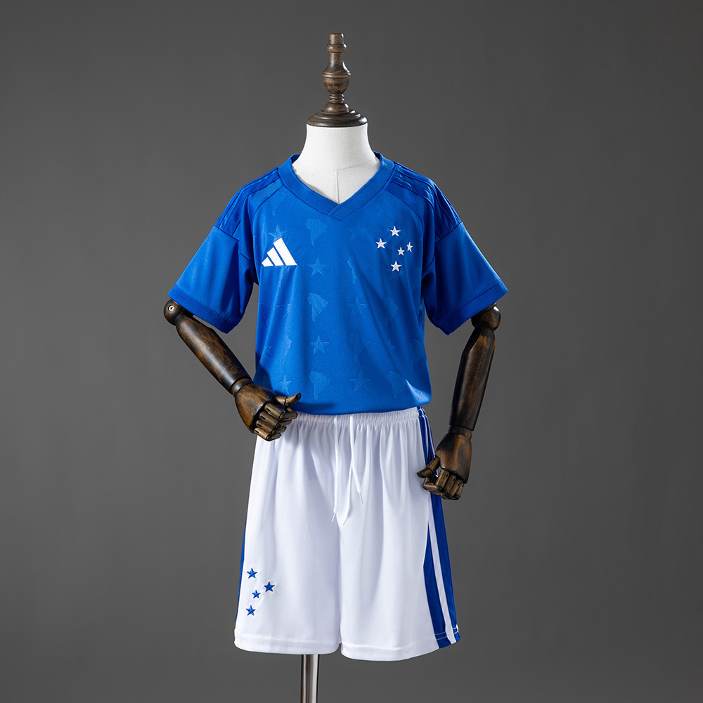 Kids Cruzeiro Home Kit 2026 Front view of the Kids Cruzeiro Home Kit 2026 showing royal blue V-neck jersey and matching white shorts
