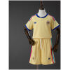 Front view of the Kids Curacao Away Kit 2026 showcasing pastel yellow fabric, colorful shoulder stripes, and matching yellow shorts on a mannequin.