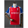 Red Universidad Catolica away jersey with blue sleeves front view
