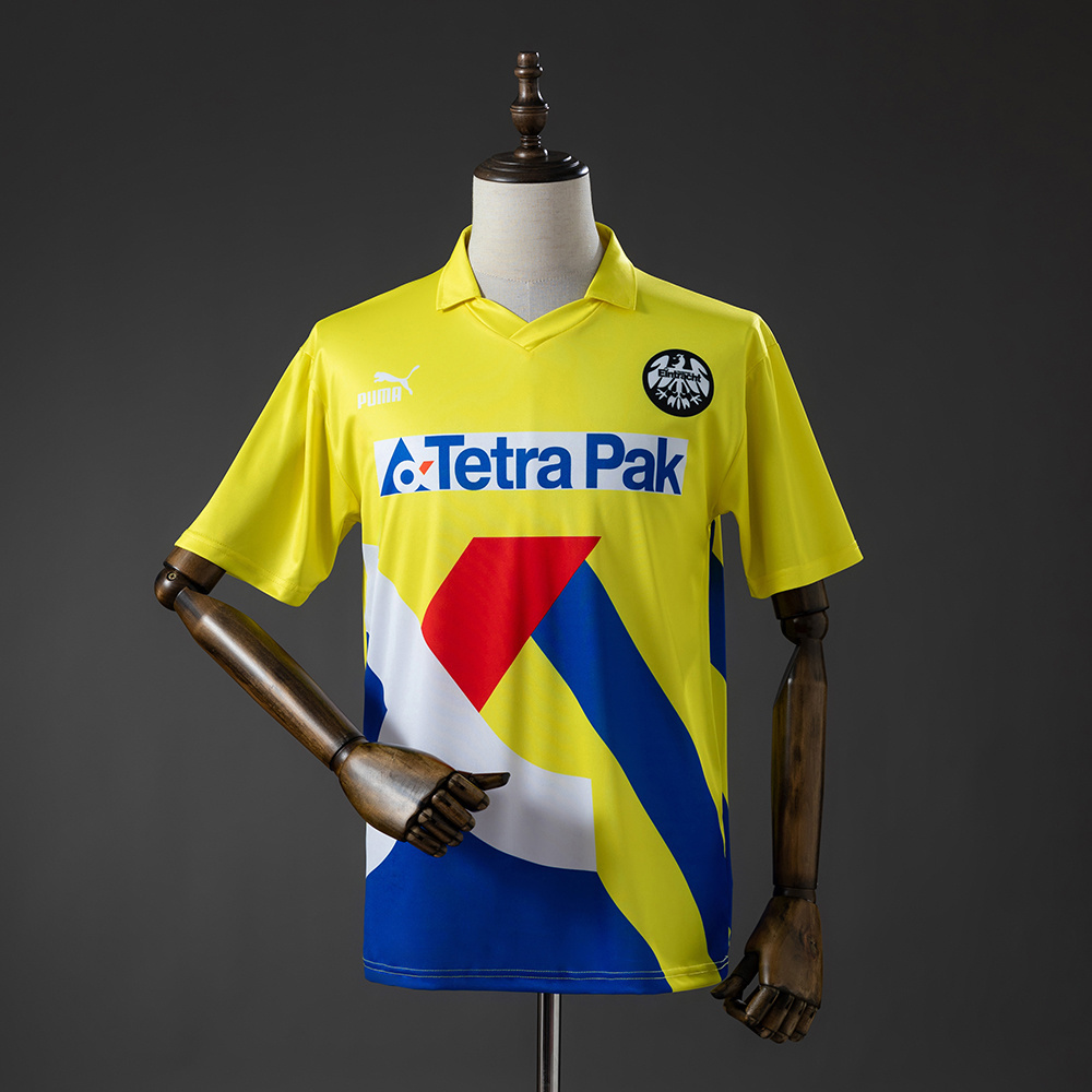 Mens Frankfurt Retro Away Jersey 1993/96 Front view of the Mens Frankfurt Retro Away Jersey 1993/96 in yellow with geometric color-blocking and Tetra Pak logo