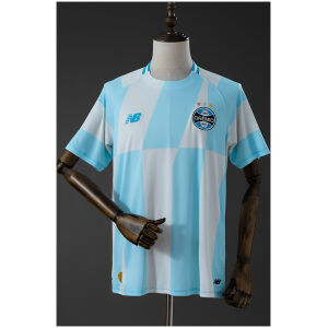 Mens Gremio Away Jersey 2026/27 Mens Gremio Away Jersey 2026/27 front view in sky blue and white with geometric block pattern and crest