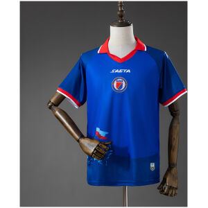 Mens Haiti Home Jersey 2026 front view in royal blue with red winged collar and centered FHF crest
