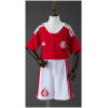 Front view of the Kids Internacional Home Kit 2026/27 including red home shirt and matching white shorts