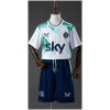 Front view of the Kids Ireland Away Kit 2026 featuring white geometric pattern jersey, Sky sponsor, and navy shorts