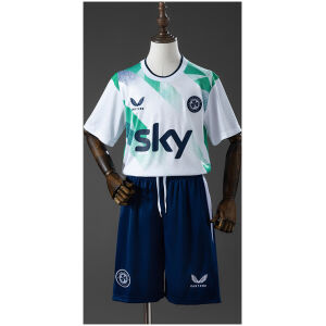 Front view of the Kids Ireland Away Kit 2026 featuring white geometric pattern jersey, Sky sponsor, and navy shorts