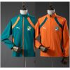Green and orange reversible jacket with Ivory Coast elephant crest, front view
