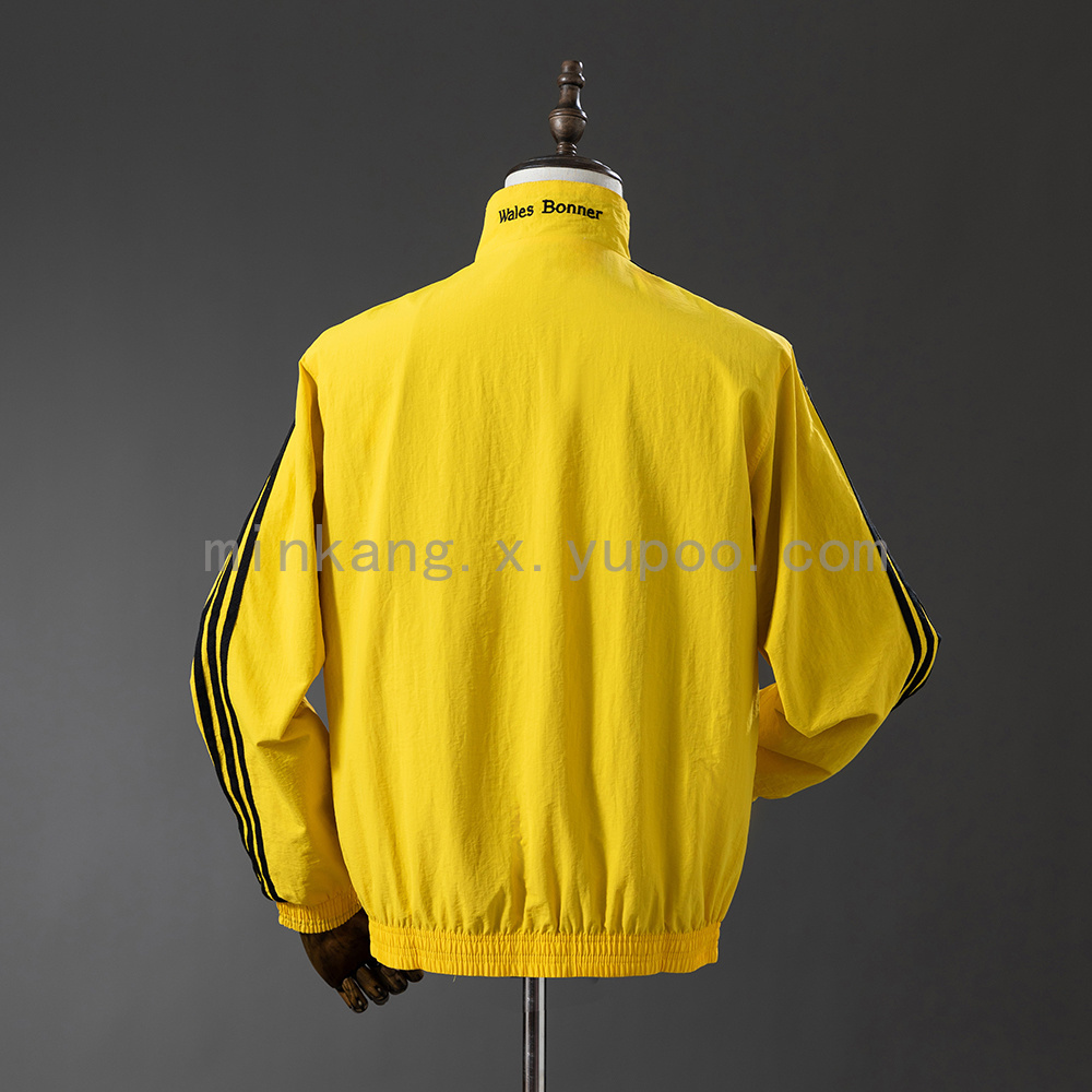 Mens Jamaica Trench Coat Reversible yellow and Black Windbreaker 2025 Mens Jamaica Trench Coat Reversible Yellow and Black Windbreaker 2025 yellow side rear view with Wales Bonner collar print