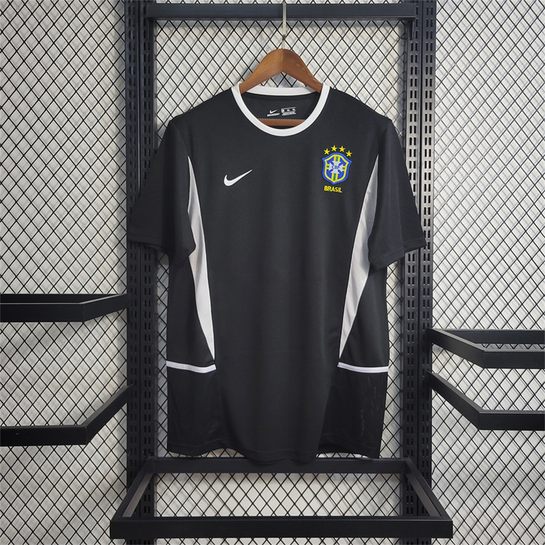 Mens World Cup Brazil Black Retro Goalkeeper Jersey 2002 Mens World Cup Brazil Black Retro Goalkeeper Jersey 2002 black shirt front view on hanger with white piping and CBF crest