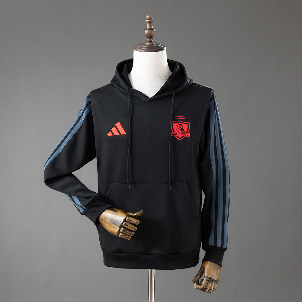 Mens Colo Colo Sweatshirt 2026/27 Mens Colo Colo Sweatshirt 2026/27 front view in black fleece with neon orange crest, adidas logo, and kangaroo pocket