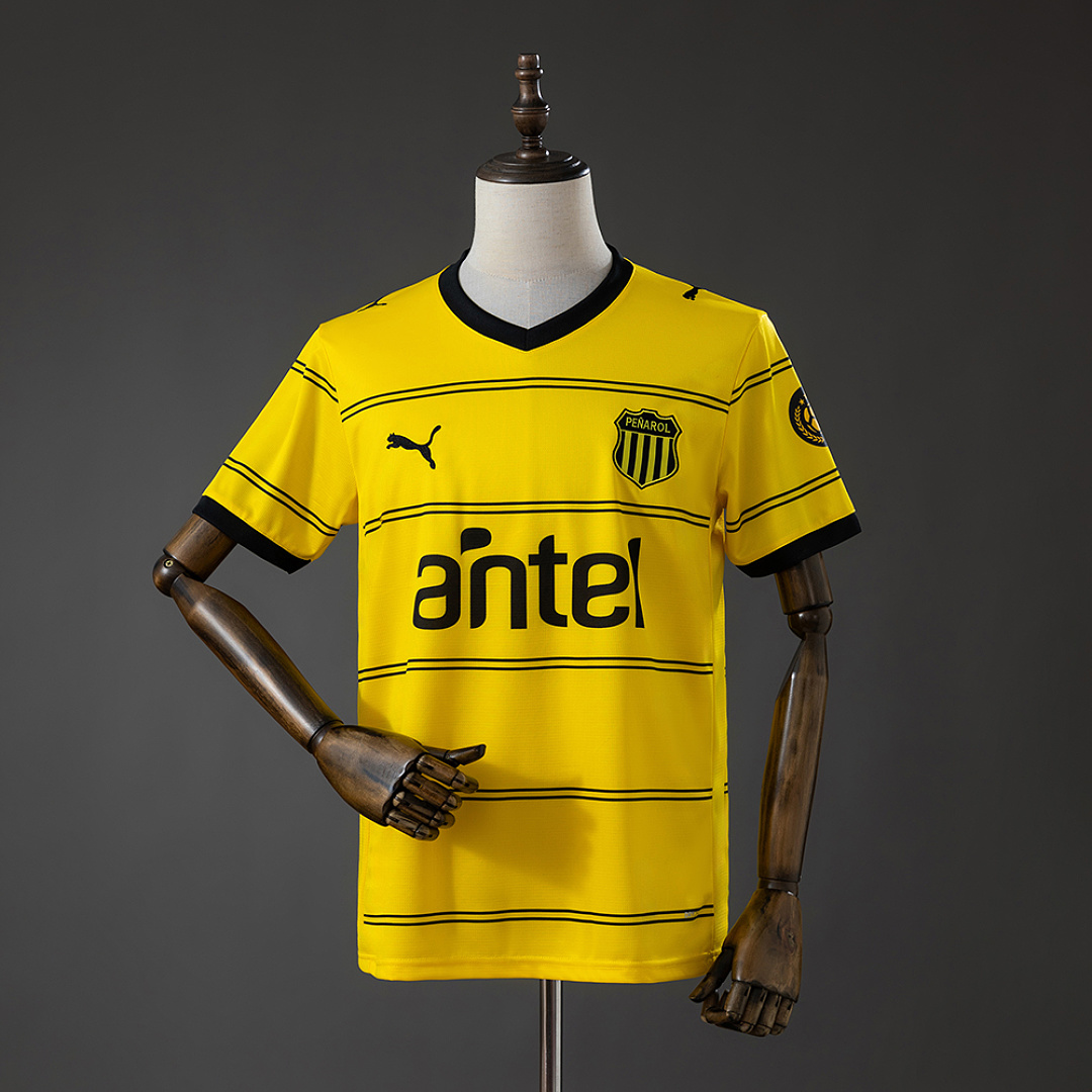 Mens Club Atlético Peñarol Away Jersey 2026/27 Front view of Mens Club Atlético Peñarol Away Jersey 2026/27 in yellow with black pinstripes