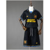 Kids Manchester United Retro Away Kit 1993/94 front view showing black jersey with yellow trims and matching shorts