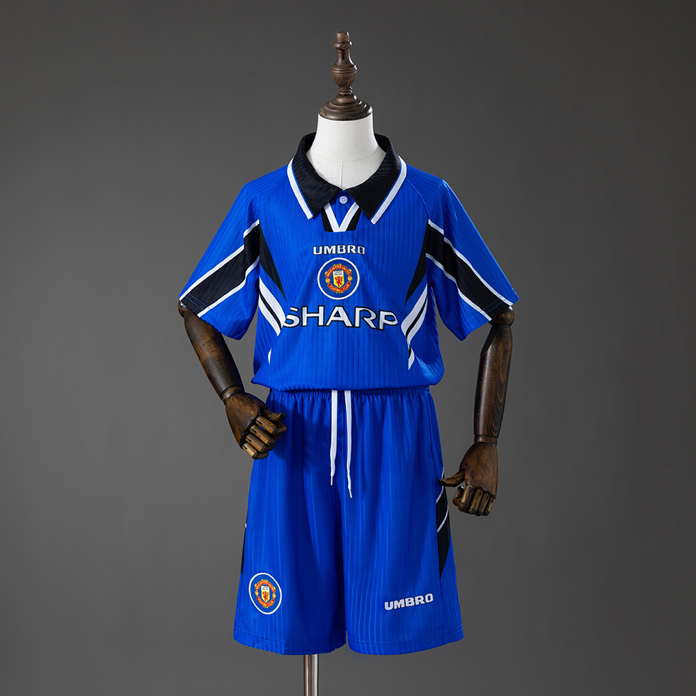 Kids Manchester United Retro Third Kit 1996/98 Kids Manchester United Retro Third Kit 1996/98 front view showing royal blue shirt with slash details and blue shorts