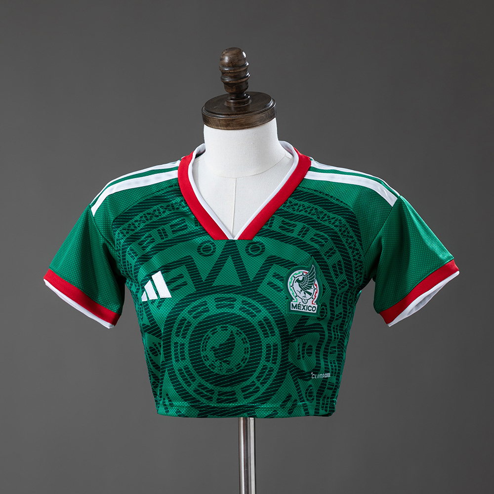 Womens Mexico Style Home Crop Top 2026 Womens Mexico Style Home Crop Top 2026 front view in green with Aztec sun stone pattern and crest
