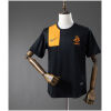 Front view of the Mens Netherlands Retro Away Jersey 2012 in black with orange shoulder block and KNVB crest