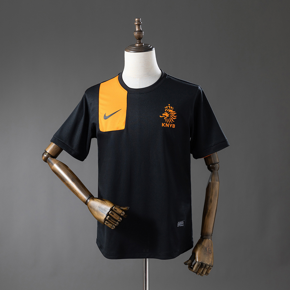 Mens Netherlands Retro Away Jersey 2012 Front view of the Mens Netherlands Retro Away Jersey 2012 in black with orange shoulder block and KNVB crest