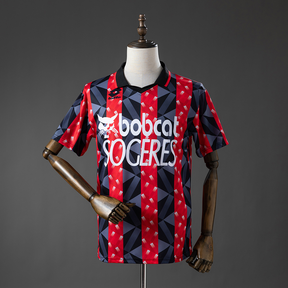 Mens OGC Nice Retro Home Jersey 1993/94 Front view of the Mens OGC Nice Retro Home Jersey 1993/94 in red and black geometric stripes with Bobcat sponsor
