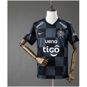 Front view of the Mens Olimpia Away Jersey 2026/27 in charcoal checkerboard pattern with white sponsor graphics