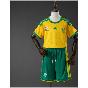 Kids South Africa Home Kit 2026 front view featuring yellow jersey with green trim and green shorts