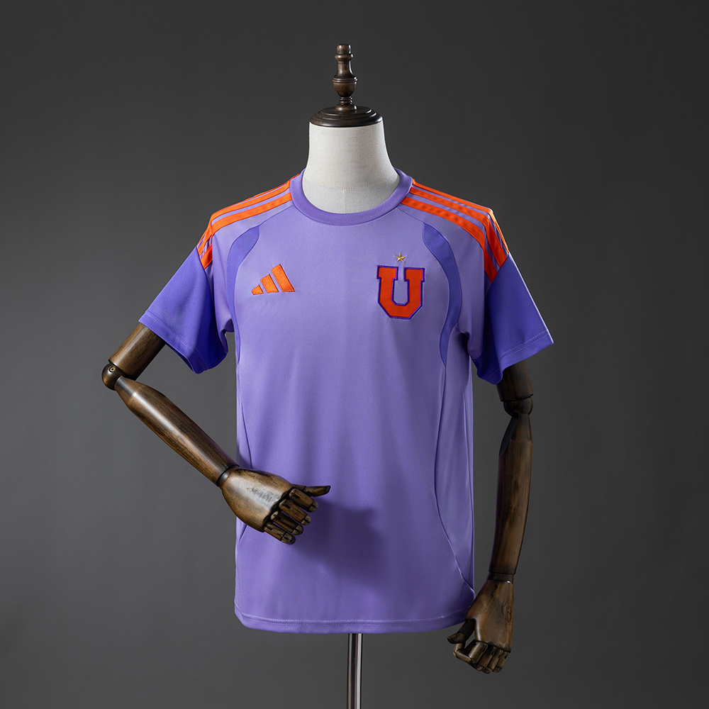 Mens Universidad Jersey 2026/27 Front view of the Mens Universidad Jersey 2026/27 in lavender with neon orange stripes and U crest