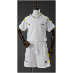 Kids Venezuela Away Kit 2026 Kids Venezuela Away Kit 2026 front view in off-white with tricolor stripes and matching shorts
