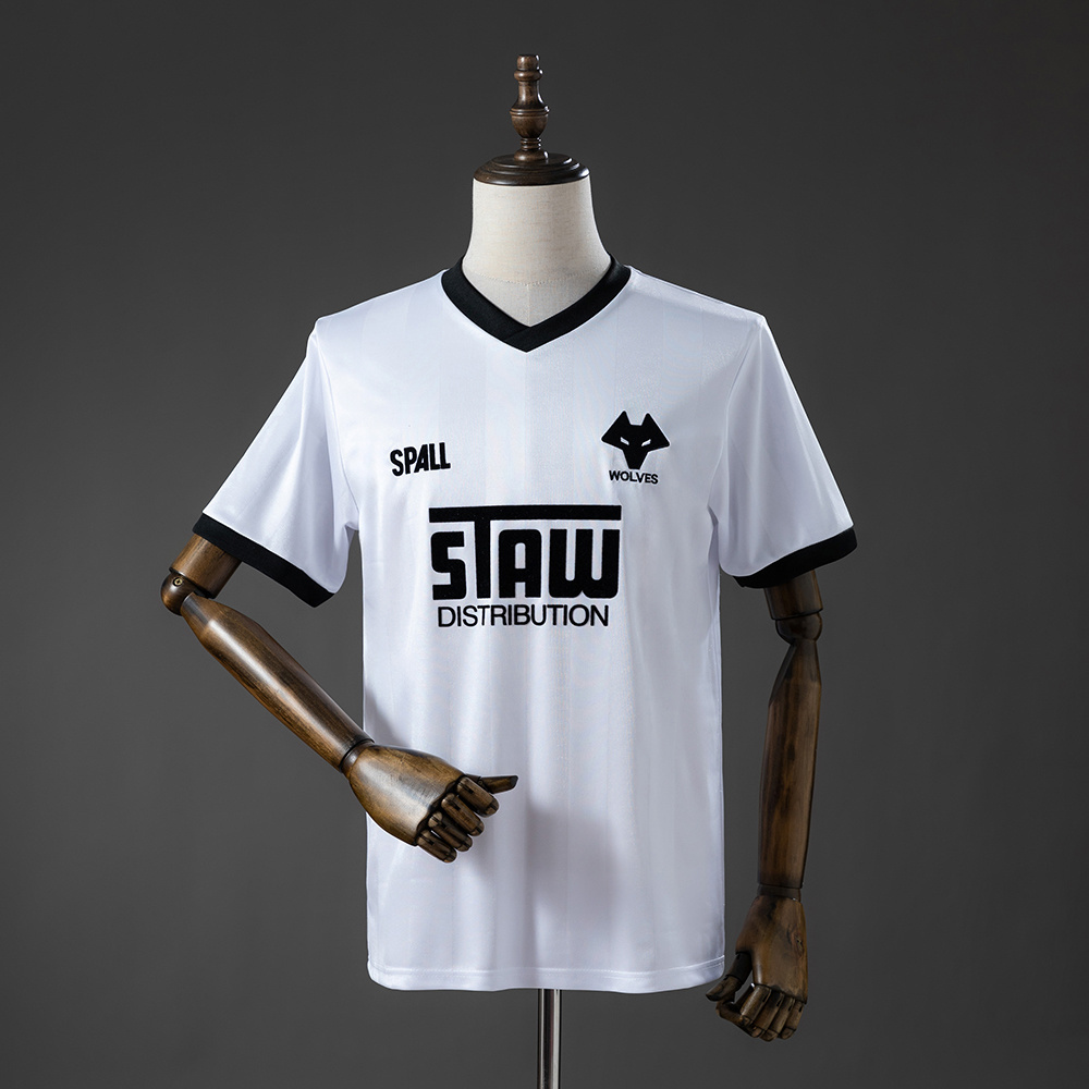 Mens Wolverhampton Wanderers Wolves Retro Away Jersey 1986/88 Front view of the Mens Wolverhampton Wanderers Wolves Retro Away Jersey 1986/88 in white with black collar and wolf crest