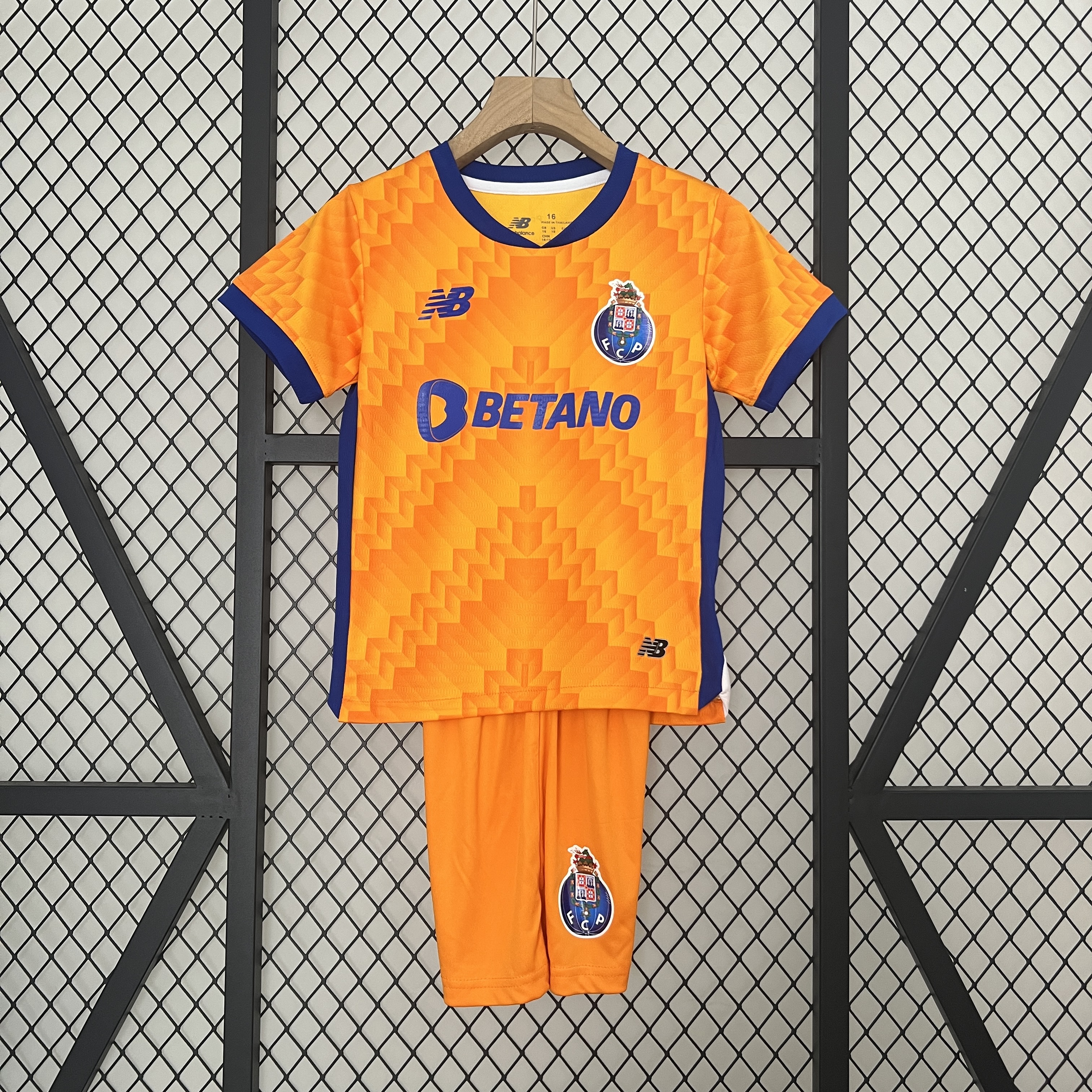 Kids Porto Away Kit 2024/25 Kids Porto Away Kit 2024/25 front view with shirt and matching orange shorts