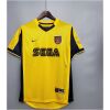 Mens Arsenal Retro Away Jersey 1999/00 on hanger showing vibrant yellow body with navy side panels, cannon crest, and SEGA logo