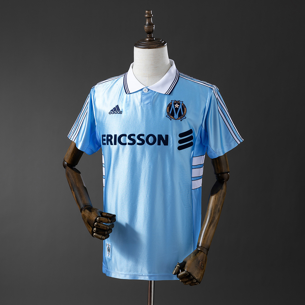 Mens Marseille Retro Away Jersey 1998/99 Mens Marseille Retro Away Jersey 1998/99 on mannequin showing sky blue body with white polo collar and Ericsson logo