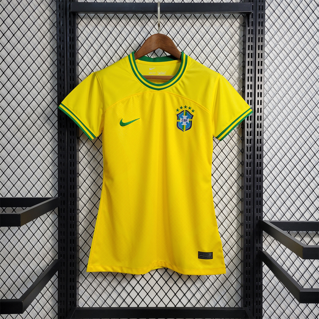 Womens World Cup Brazil Commemorative Edition Yellow Jersey 2022 Womens World Cup Brazil Commemorative Edition Yellow Jersey 2022 on hanger showing yellow body with green trim