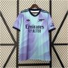 Mens Arsenal Third Jersey 2024/25 on display rack showing lilac and mint green wave gradient body with dark navy collar