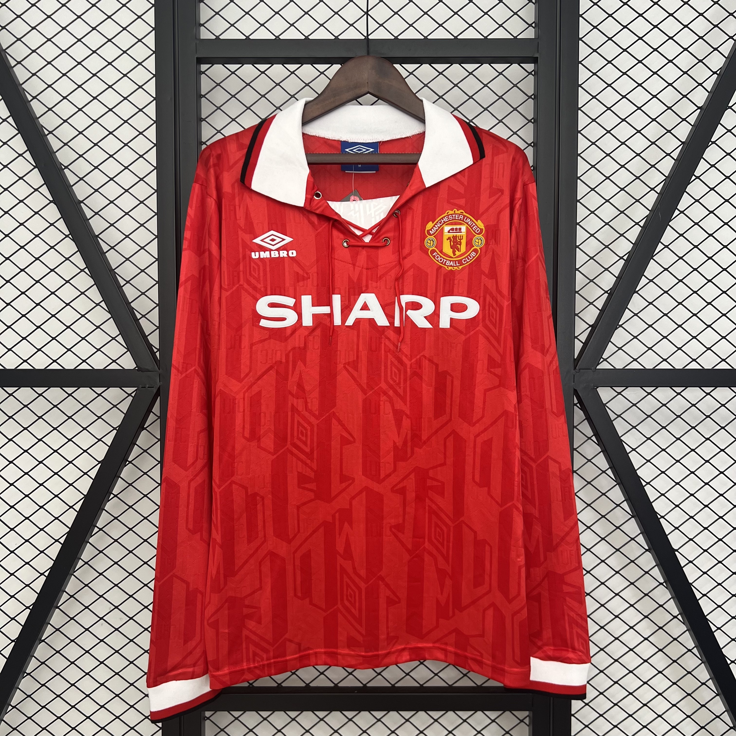 Mens Manchester United Retro Long Sleeve Home Jersey 1992/94 Mens Manchester United Retro Long Sleeve Home Jersey 1992/94 on hanger showing red jacquard body with lace-up collar