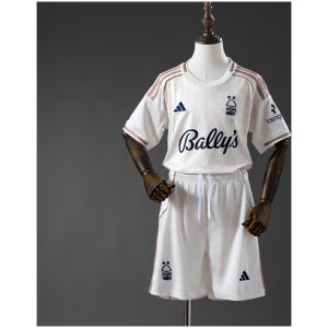 Kids Nottingham Forest Away Kit 2025/26 set flat lay showing off-white jersey with copper stripes and white shorts