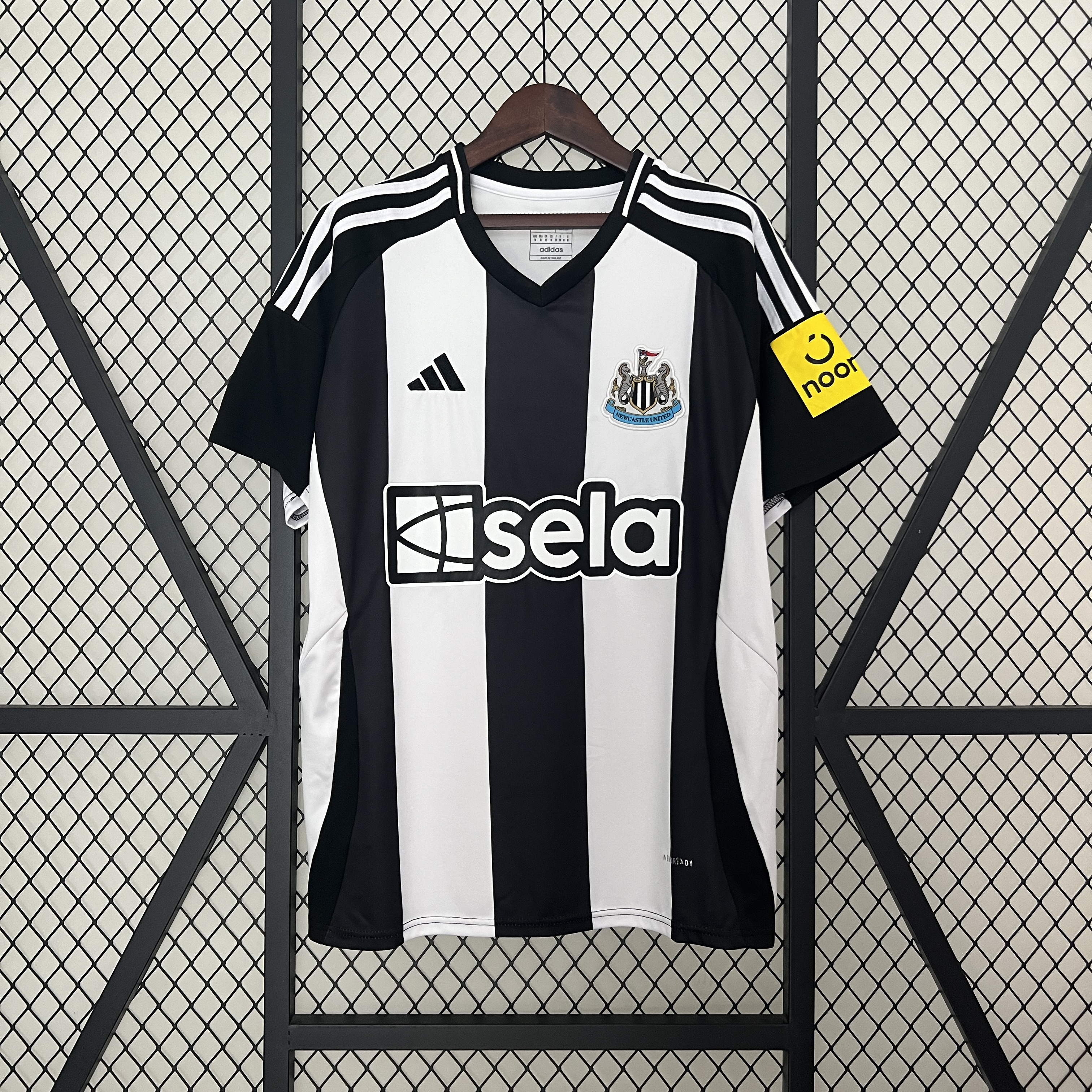 Mens Newcastle United Home Jersey 2024/25 Mens Newcastle United Home Jersey 2024/25 on hanger showing black and white stripes with black sleeves and sela