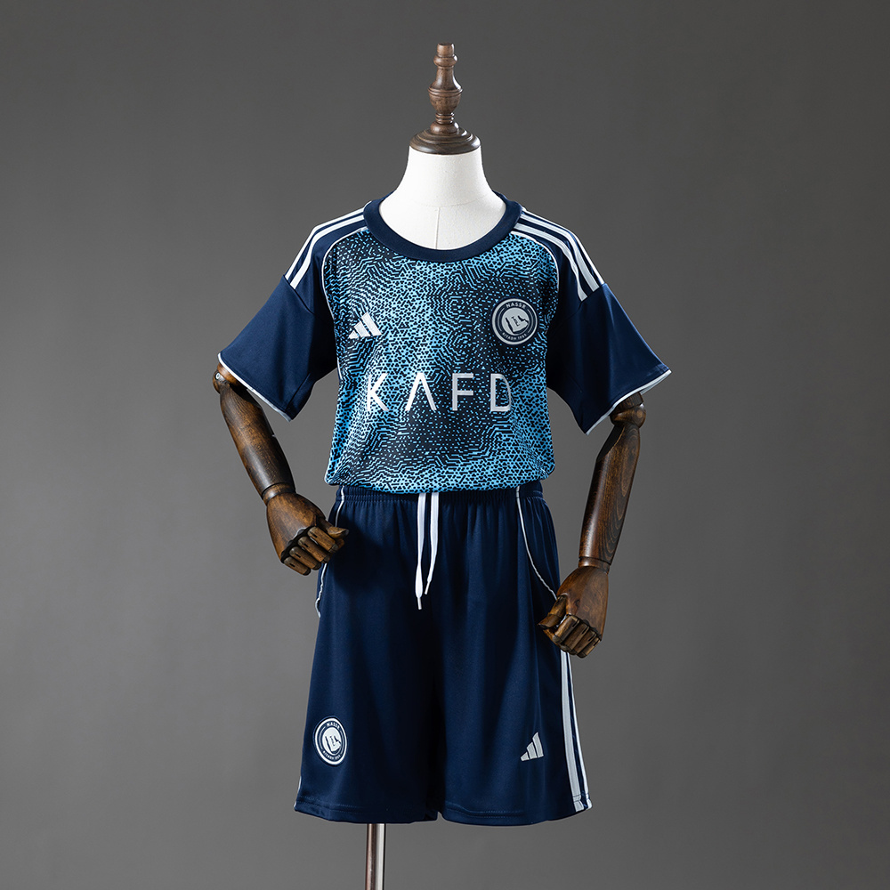 Kids Al Nassr Away Kit 2025/26 Kids Al Nassr Away Kit 2025/26 front view showing navy patterned jersey and shorts