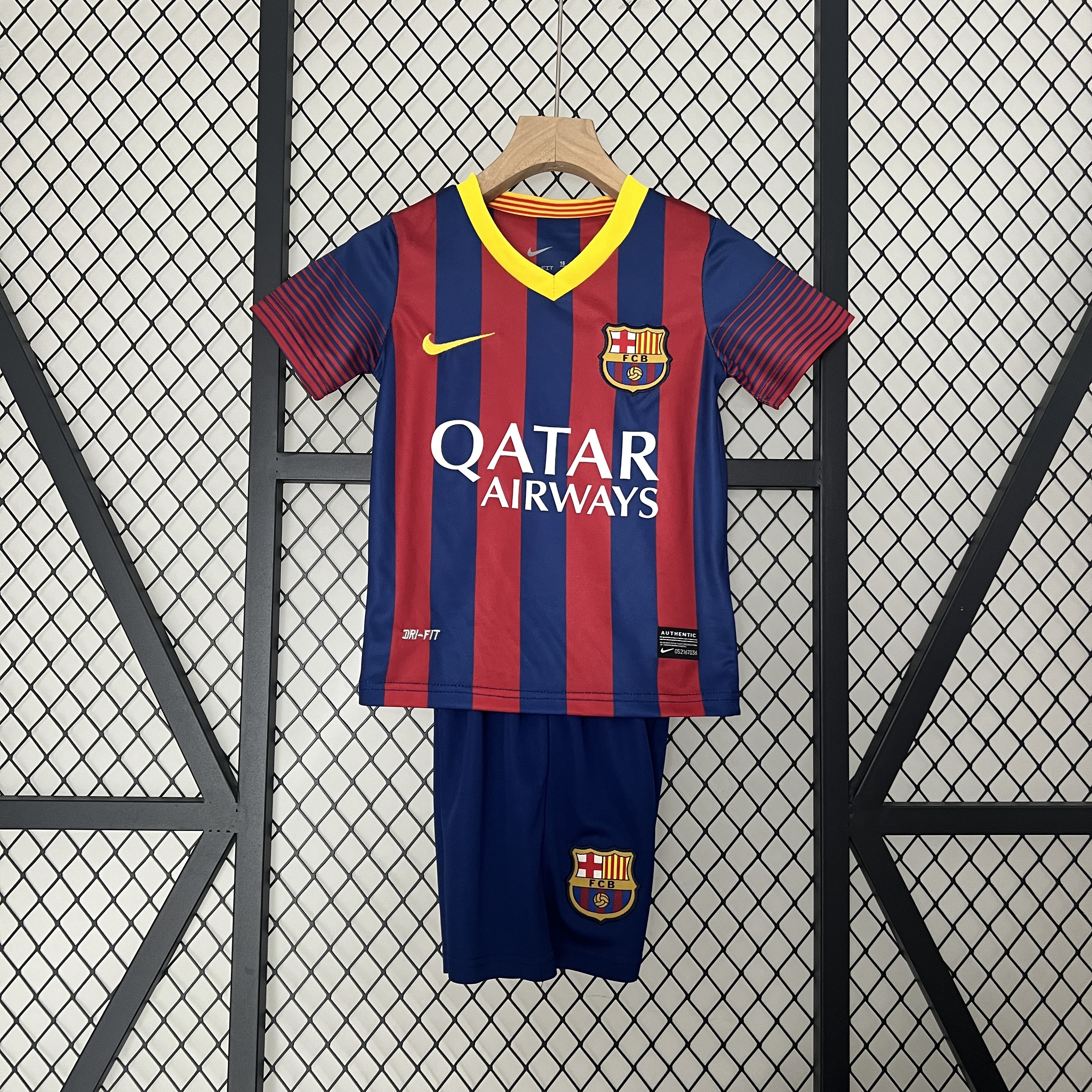 Kids Barcelona Retro Home Kit 2013/14 Kids Barcelona retro home kit with blaugrana stripes and yellow V-neck front view