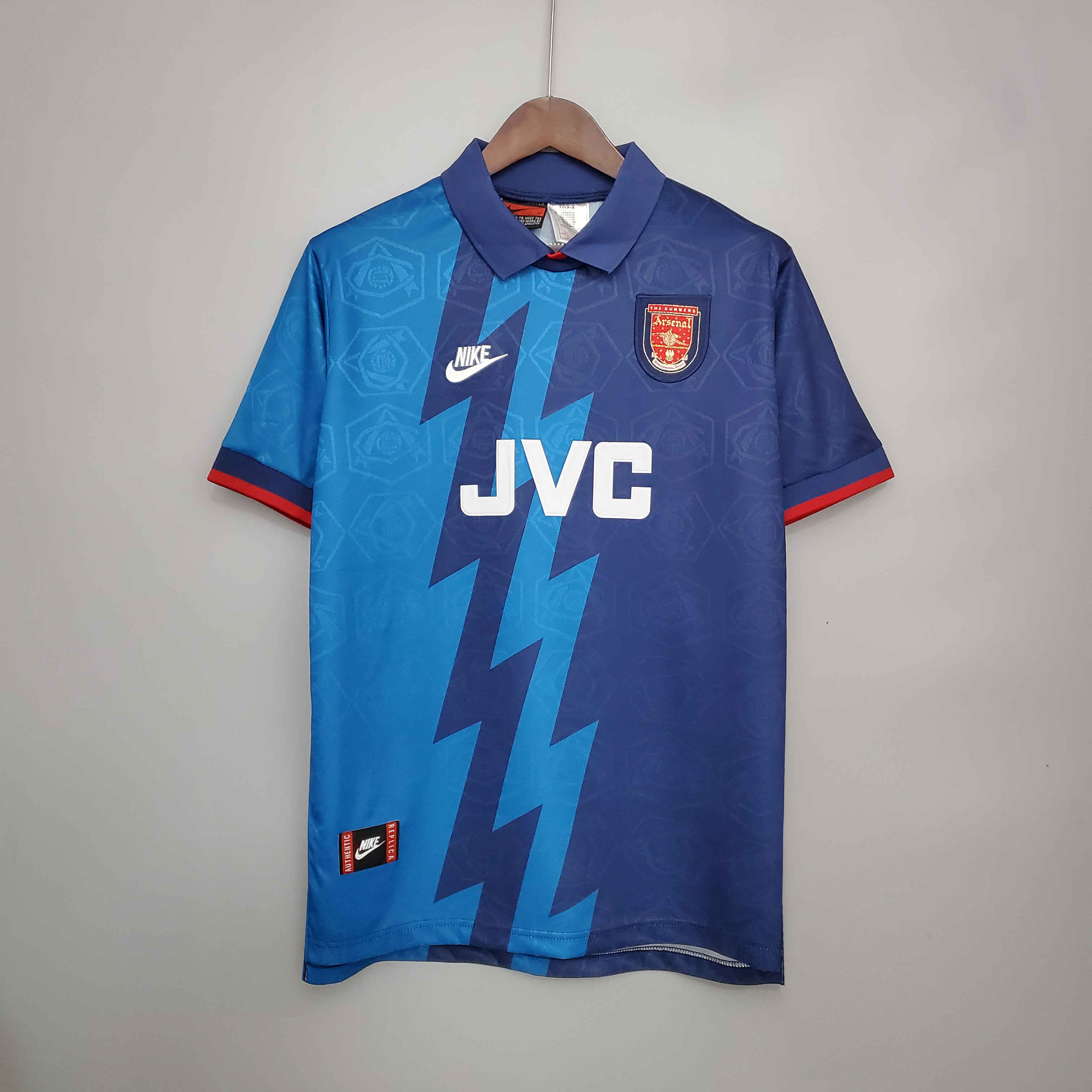 Mens Arsenal Retro Away Jersey 1995/96 Mens Arsenal Retro Away Jersey 1995/96 on hanger showing cyan and navy lightning bolt split with JVC sponsor