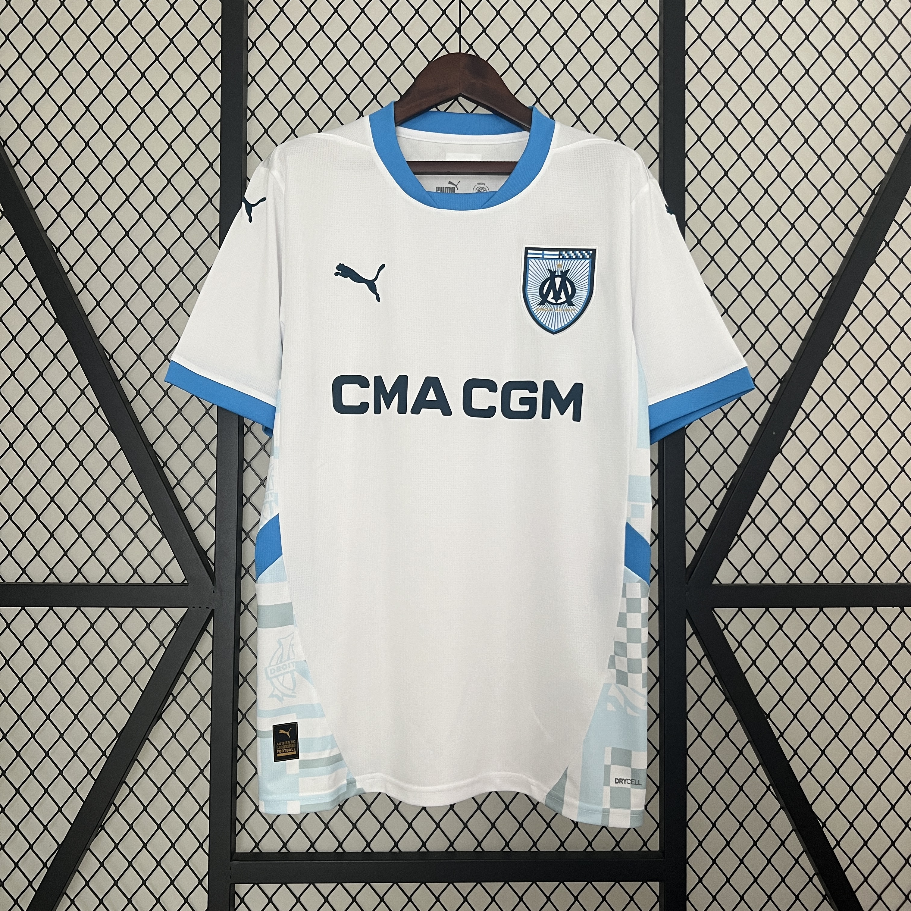 Mens Marseille Home Jersey 2024/25 Mens Marseille Home Jersey 2024/25 on hanger showing white body with sky blue trims and patterned hem panels