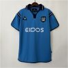 Mens Manchester City Retro Home Jersey 2001/02 on hanger showing sky blue body with navy collar and white EIDOS sponsor
