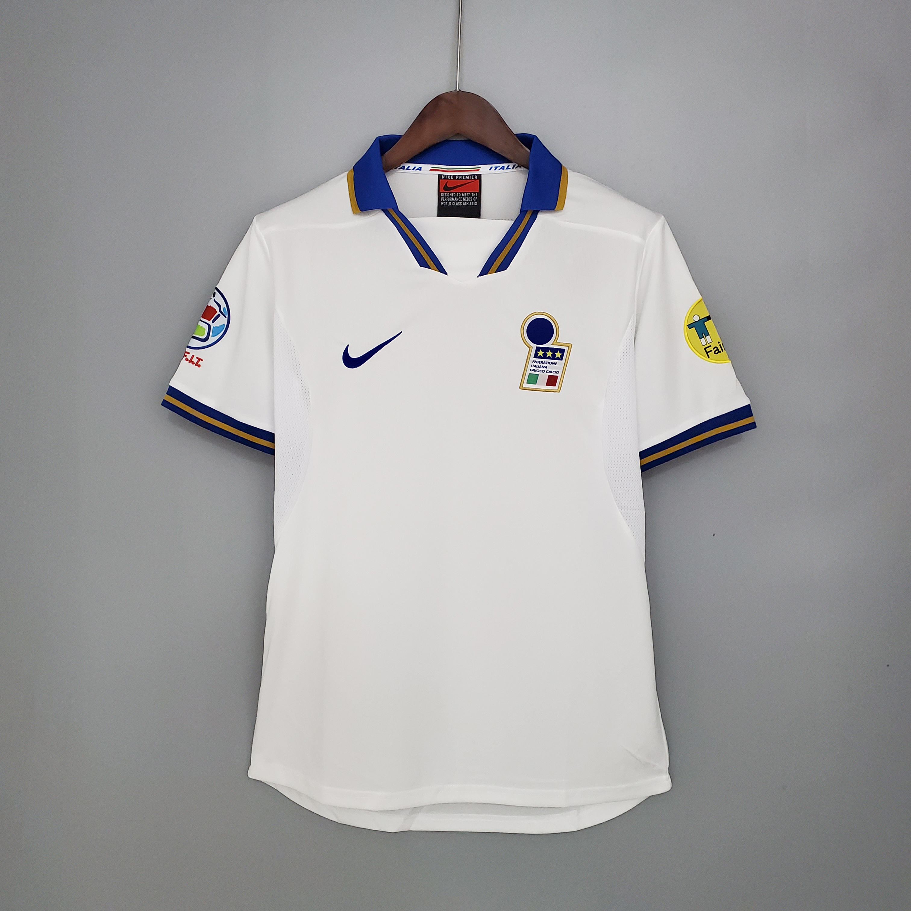 Mens Italy Retro Away Jersey 1996 Mens Italy Retro Away Jersey 1996 front view on hanger showing blue spread collar and embroidered FIGC crest