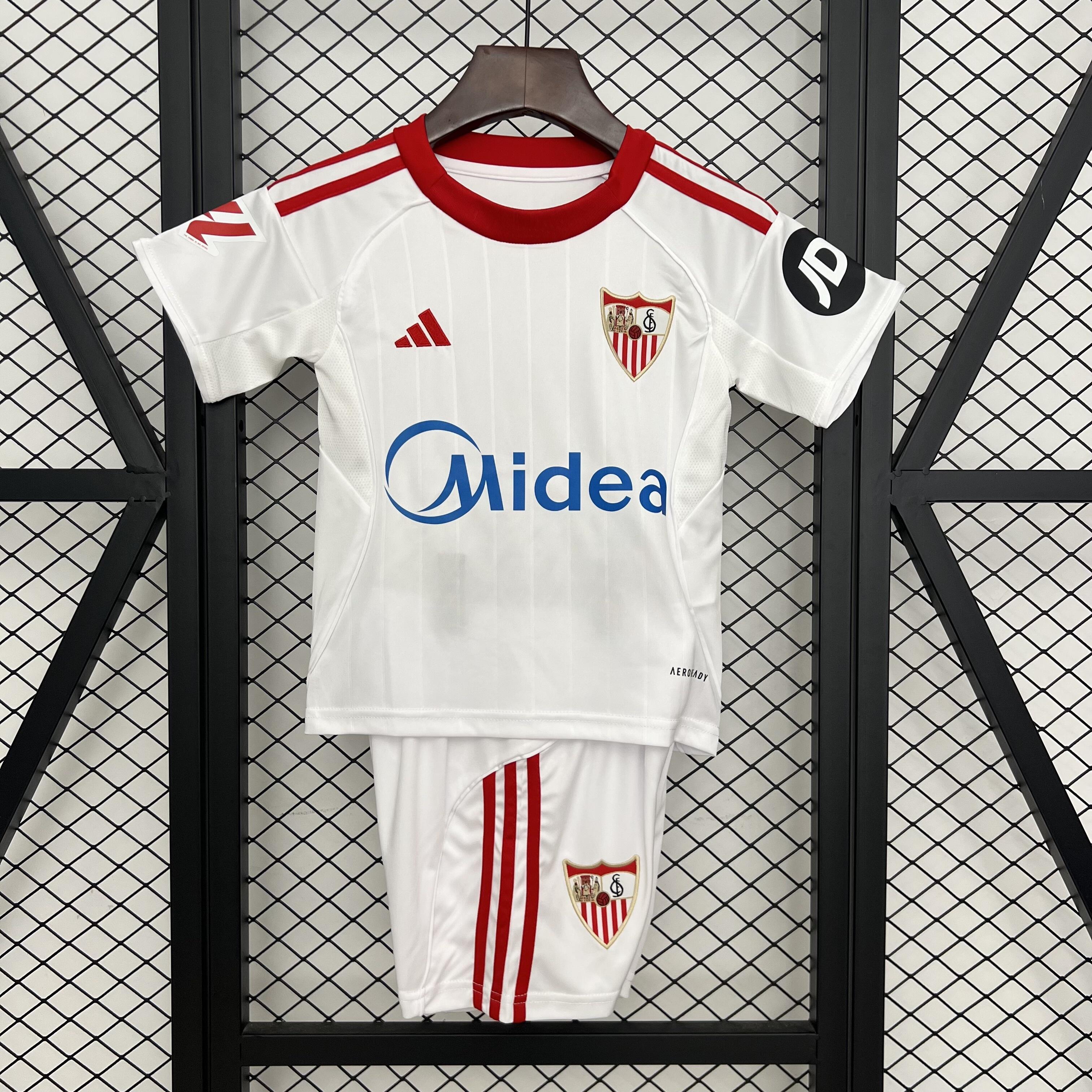 Kids Sevilla Home Kit 2025/26 Kids Sevilla Home Kit 2025/26 front view on display