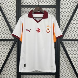 Mens Galatasaray Away Jersey 2025/26 on hanger showing white body with maroon polo collar and orange underarm panels