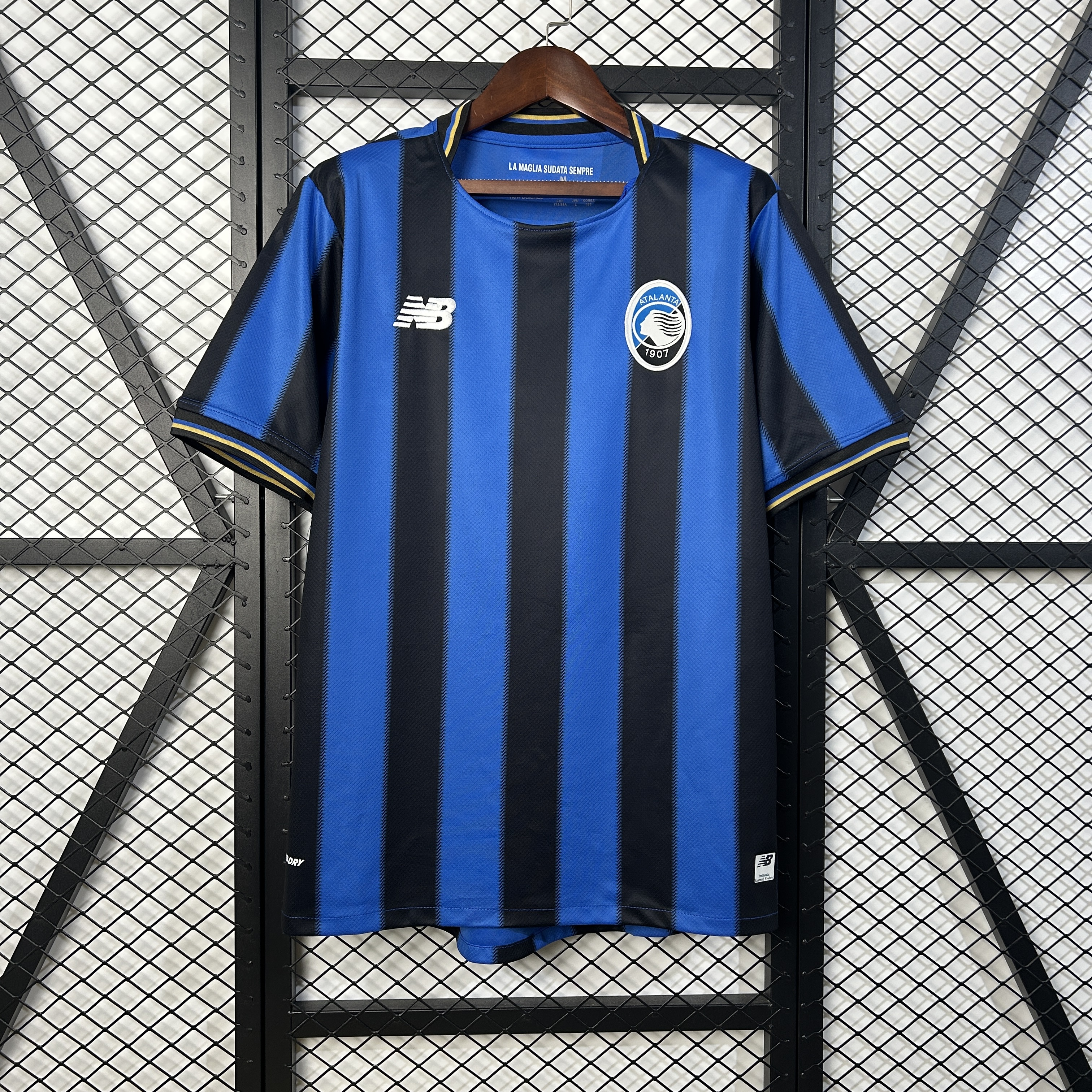 Mens Atalanta BC blue Home Jersey 2025/26 Mens Atalanta BC blue Home Jersey 2025/26 on hanger displaying royal blue and black vertical stripes with oval crest