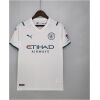 Mens Manchester City Away Jersey 2021/22 on hanger showing white body with teal shoulder accents and iridescent sponsor