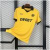 Mens Wolves Home Jersey 2025/26 on hanger showing old gold amber knit with black polo collar and central crest