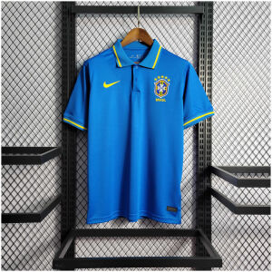 Mens World Cup Brazil Blue Polo 2022 on hanger showing blue pique body with yellow-tipped collar