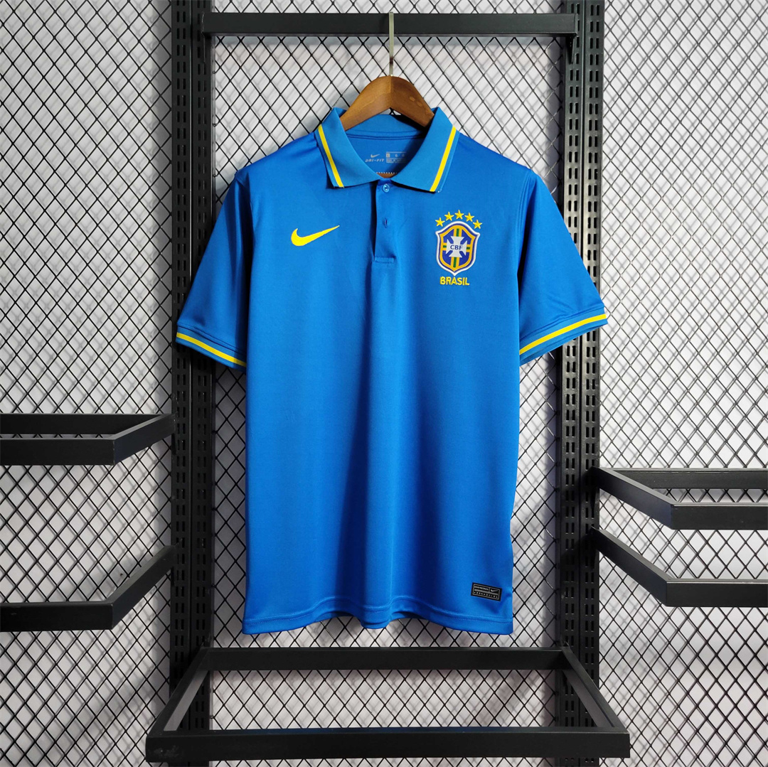 Mens World Cup Brazil Blue Polo 2022 Mens World Cup Brazil Blue Polo 2022 on hanger showing blue pique body with yellow-tipped collar