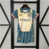 Kids Manchester City Fourth Kit 2024/25 display showing slate teal and pale yellow shirt with matching athletic shorts