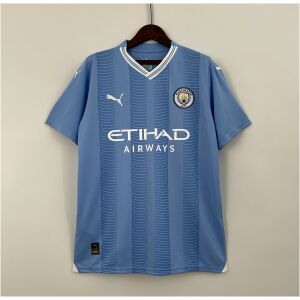 Mens Manchester City Home Jersey 2023/24 on hanger showing sky blue body with embossed vertical stripes and white sponsor